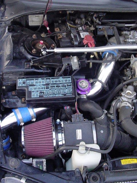My engine bay (cone filter, metal UICP, GReddy BOV, and strut tower bar)