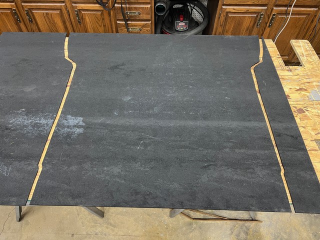 Got a roll of 1/4" rubber to use as a truck bed in the Bronco. Scribed and cut.