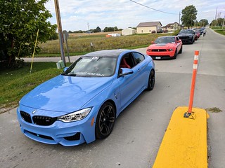 Rally cars waiting for the train to pass