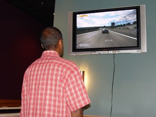 Tech - Nehru playing GT4 on the plasma
