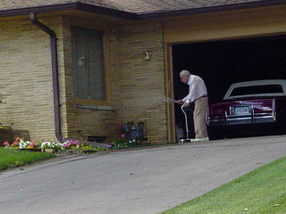 Old man watering his lawn