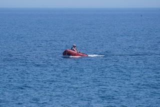 A boat cruising in from the lighthouse