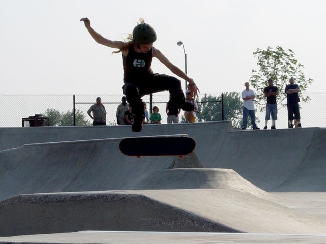 A chick stickin a kickflip at Ankeny Skatepark