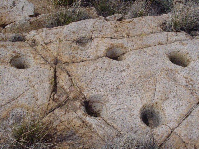 holes ground into the rocks by indians