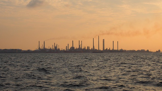Singapore factories silhouetted in a smoggy sunset