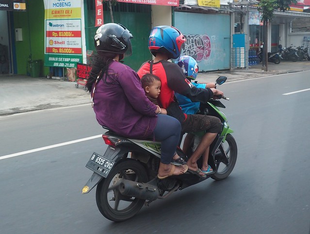 A family of four on a scooter