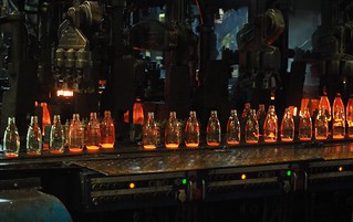 Some molten hot, freshly formed glass bottles.
