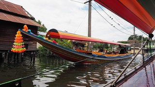 A decorated boat coming down the canal in Bangkok