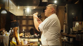 The chef at this super awesome restaurant skewerin up some fish to grill