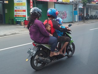 A family of four on a scooter