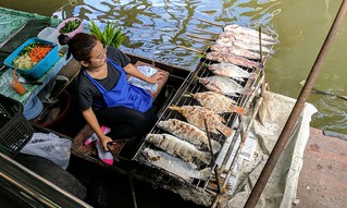 Grillin up some fish at the floating markets in Bangkok