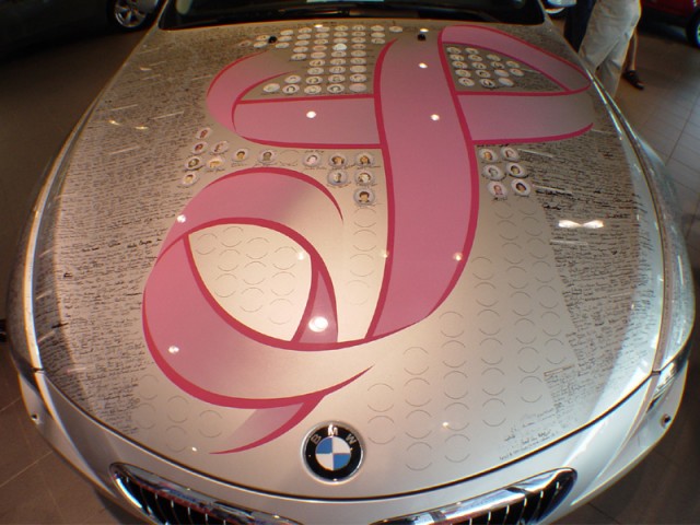 The hood of a BMW 645 coupe with signatures of all the drivers