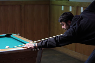 Shooting pool against the owner