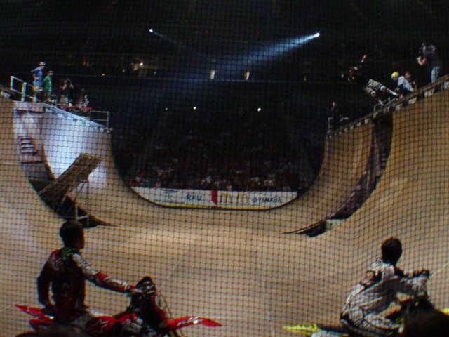 Tony Hawk, dropping in with his own deck, jumping onto Andy Macdonald's deck, and then grinding the bridge