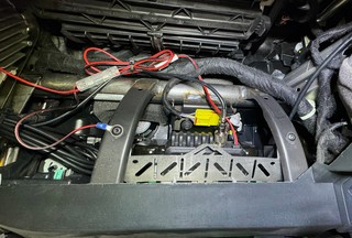 Radio tucked up into the dash, above the glovebox and wired into upfitter aux switch #6