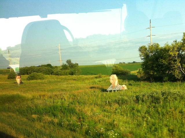 Anyone know what these weird, giant face signs are outside of Iowa City?