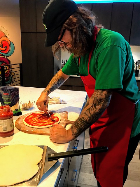 Saucing some pizzas for the grill