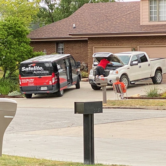 My neighbor is straight chilling in this lawn chair. Keeping tabs on some dude working on his tru...