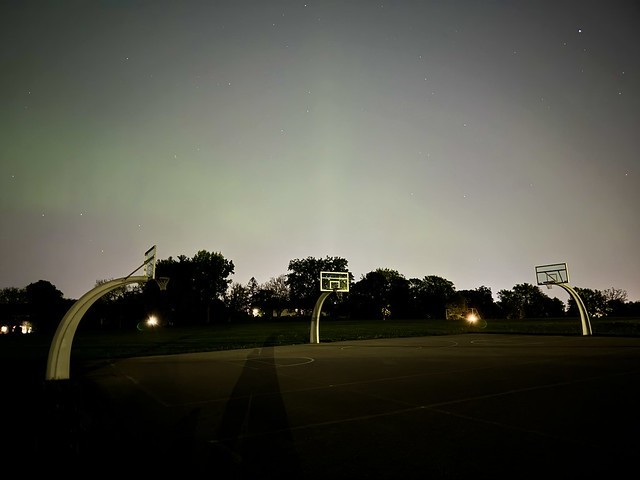 Faint northern lights through the city light pollution
