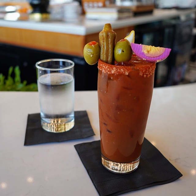 A bloody mary prepared by a bartender. And look at that pickled egg.