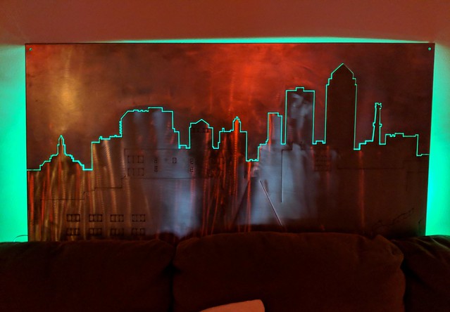 Chuck made us this stainless steel DM skyline. I threw an LED behind it for fun. It looks cool.