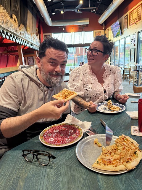 Feeding Crab Rangoon pizza to an Italian