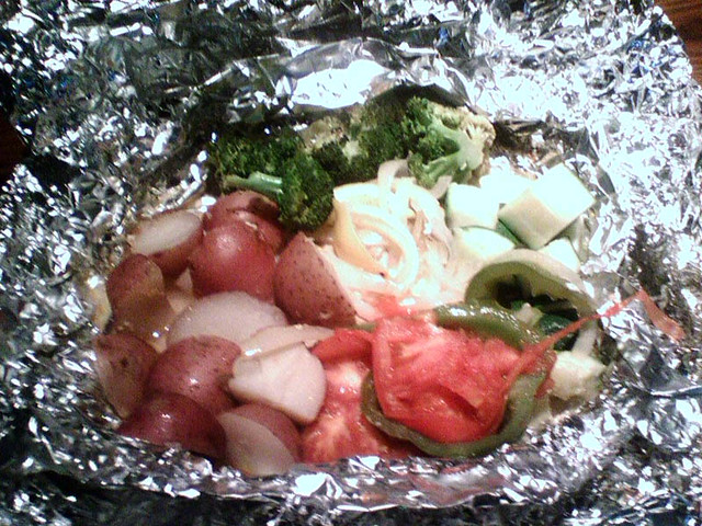 Some amazing mahi-mahi in a bag of foil with assorted awesomeness