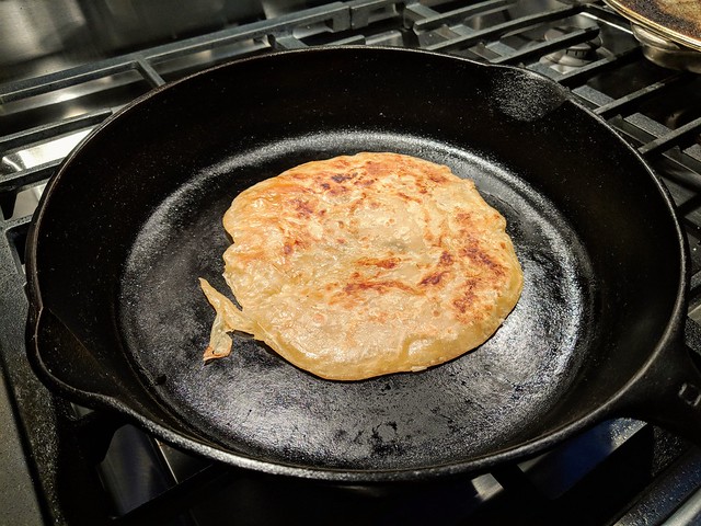Cooking up some of that tasty roti bread to go with Kiera's rendang