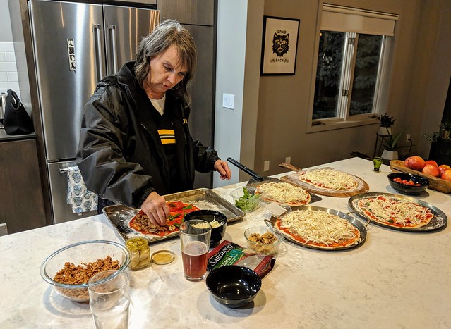 Teresa puts together a pizza
