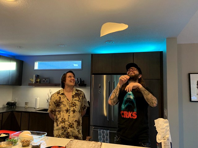 Slinging pizza dough