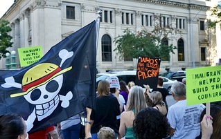 Politics - A little gathering of educators standing with their leader, and protestors against ICE