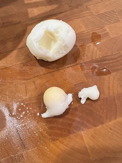 This lil baby yolk just popped out the side of this egg that has a-whole-nother yolk in it