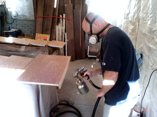 Rico spraying the seat for my bookshelves