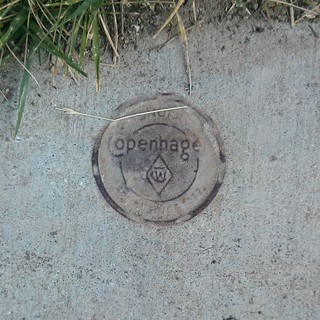 Biking - Copenhagen tobacco tin stuck in the bike path concrete