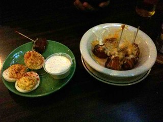 Deviled eggs and jalapeno tater tots wrapped in bacon and covered in cheese