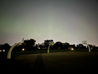 Faint northern lights through the city light pollution