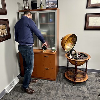 Drinks - Dropped by my financial advisor’s holiday party. He opened a globe and started pouring scotch.