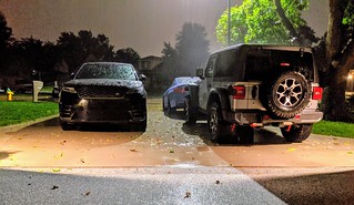 A storm rolls through while the cars sit outside... Not supposed to park on the garage floor yet.