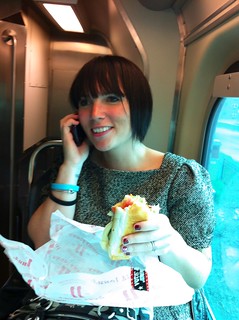 Having a deli sandwich and taking birthday calls on the train.