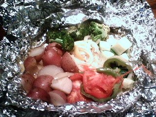 Some amazing mahi-mahi in a bag of foil with assorted awesomeness