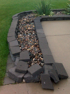 Trent ran into my landscaping.  I've gotta reset that front wall all the way around the corner.  ...