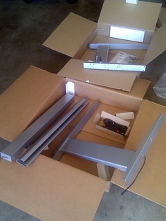 Welp, my geek desk arrived... trying to decide if I should paint the  frame black or not...