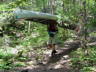 Cal portaging a canoe from Hanson to South Arm Knife Lake