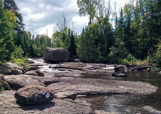 A huge boulder and stream next to one of our portages