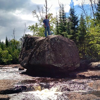 Josh climbs the boulder