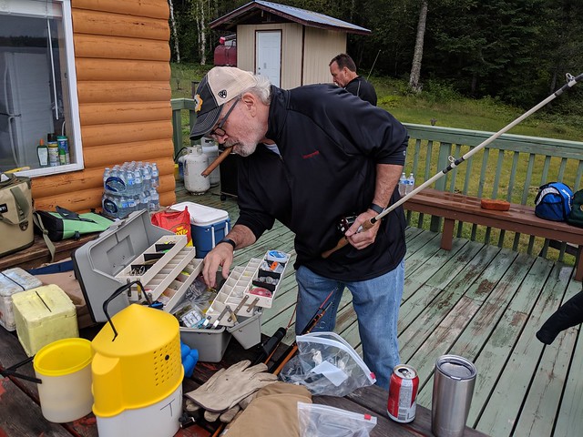 Cigar lit, beer cracked, tacklebox open