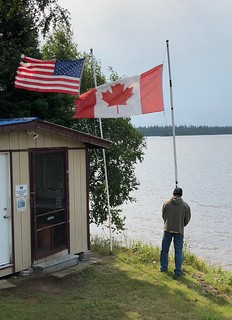 Sam makes sure the Canadian flag is a little lower than the American flag