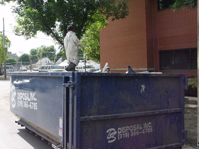 Men in white suits cleaning up