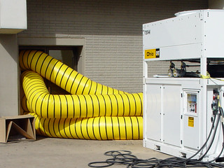 Pumping air into buildings to dry them out.