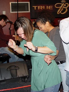 Kari getting a tambourine played on her butt